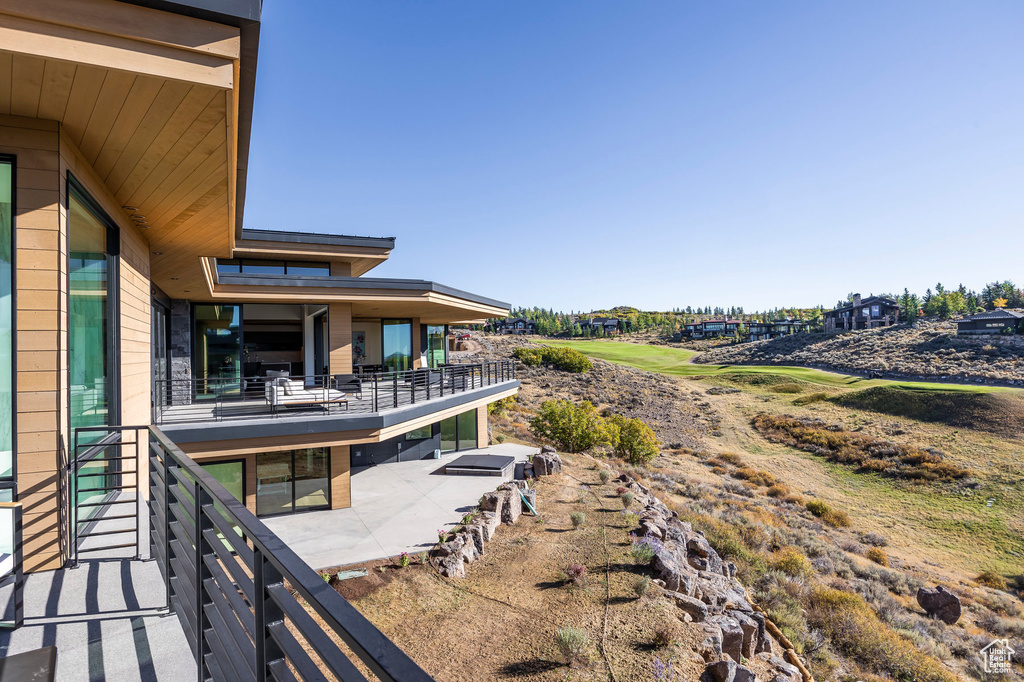 View of yard with a patio area and a balcony
