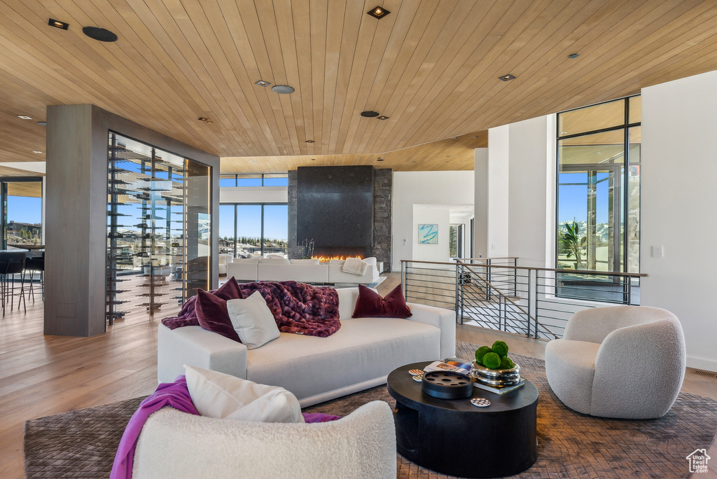 Living area featuring expansive windows, wood finished floors, and wood ceiling