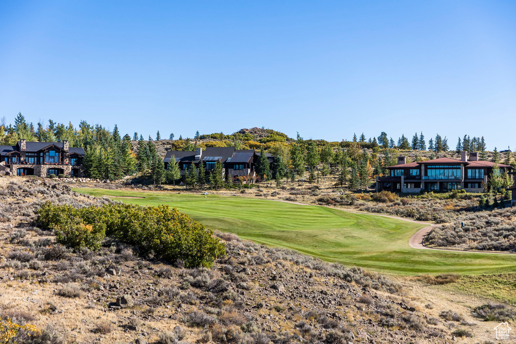 View of green lawn with view of golf course