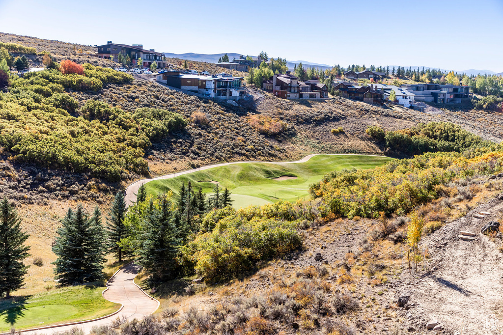Drone / aerial view of a local golf course and a mountainous background