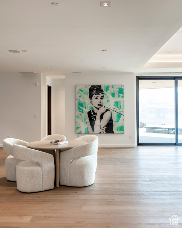 Sitting room featuring wood finished floors, baseboards, and a wall of windows