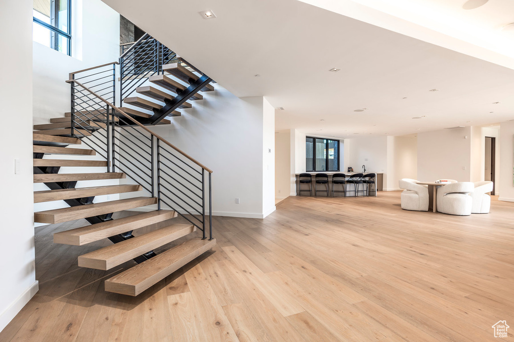 Staircase featuring wood finished floors and baseboards
