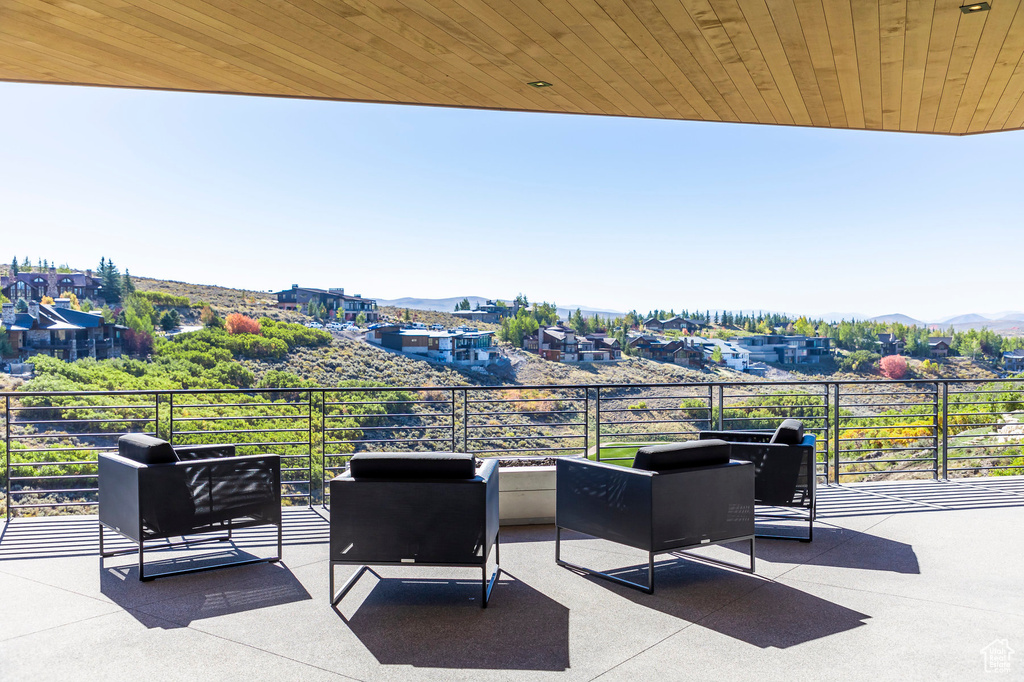 View of patio / terrace with a mountain view and a balcony