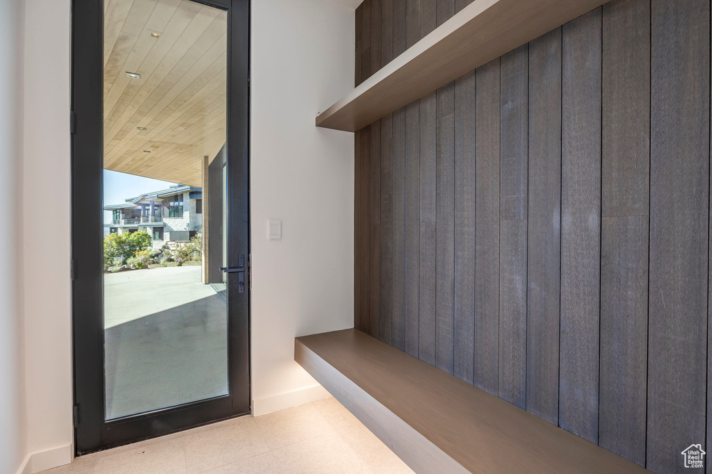 Mudroom featuring wooden ceiling and baseboards