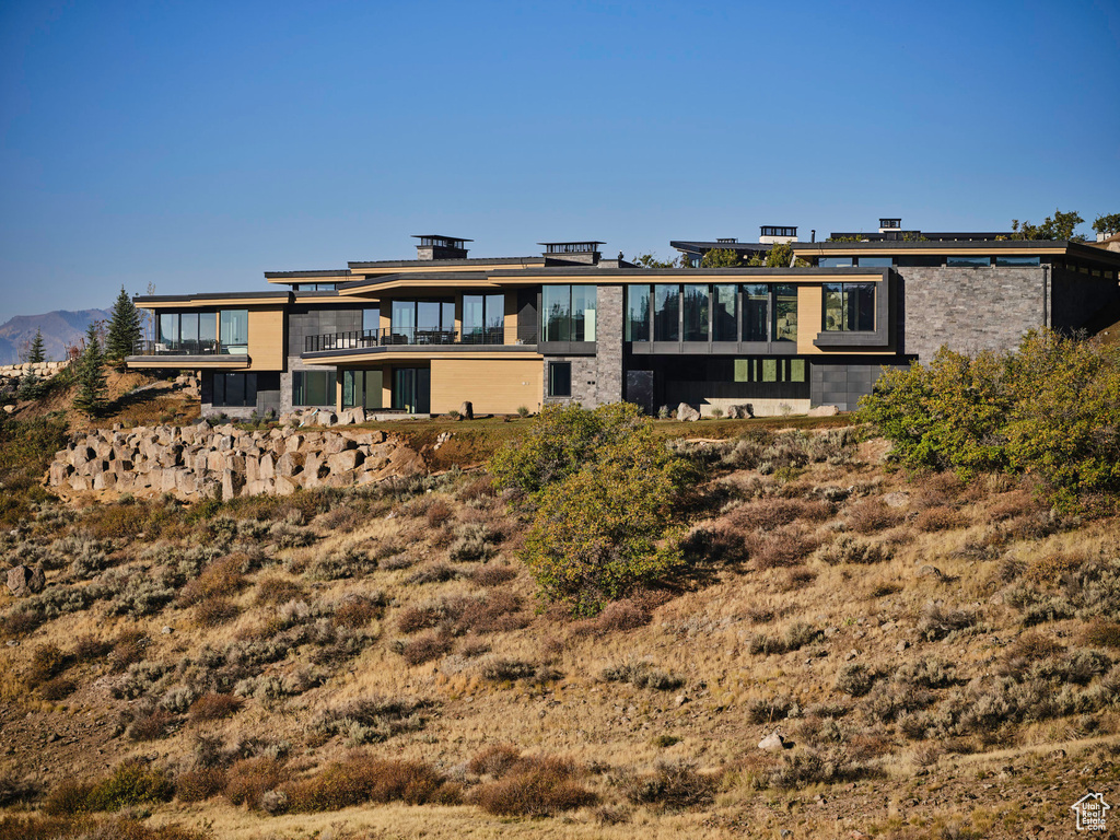 Back of property with a balcony