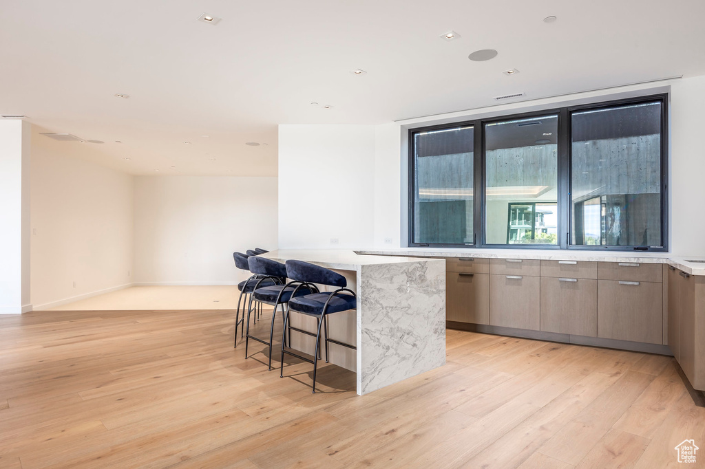 Bar area featuring light wood-style floors