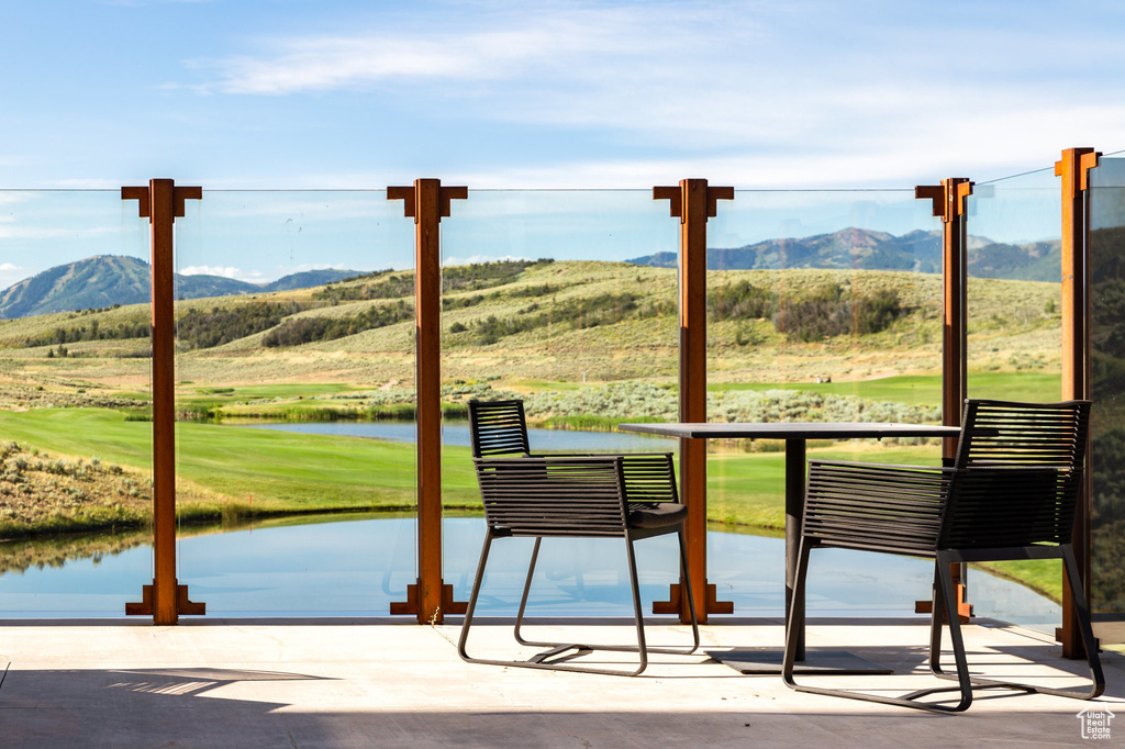 Entryway with a water and mountain view, plenty of natural light, and a wall of windows