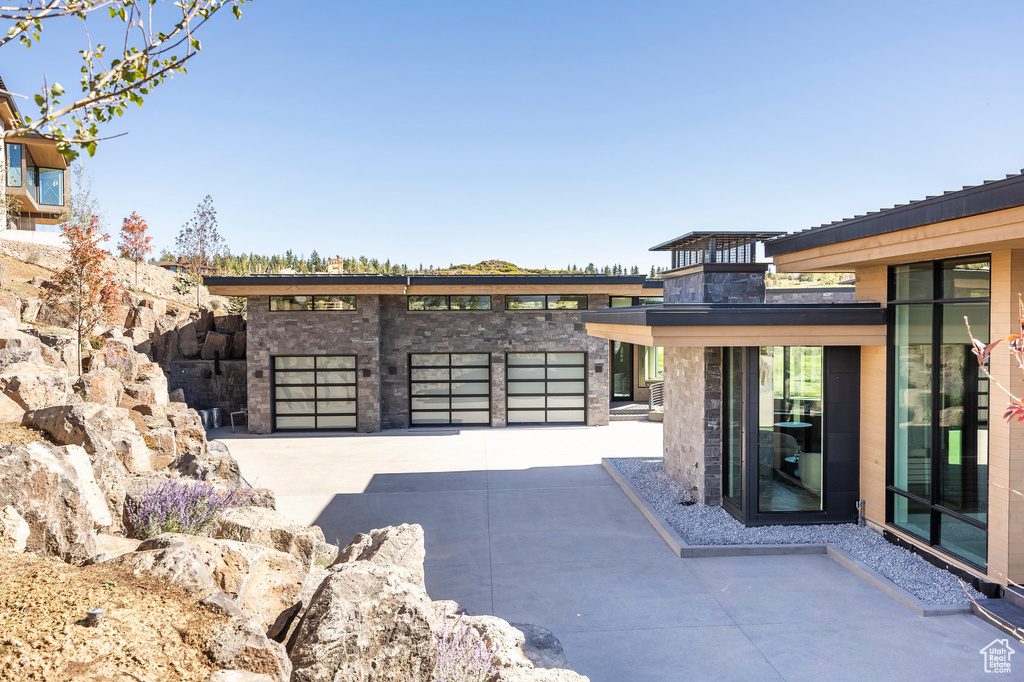 View of patio featuring a garage and driveway