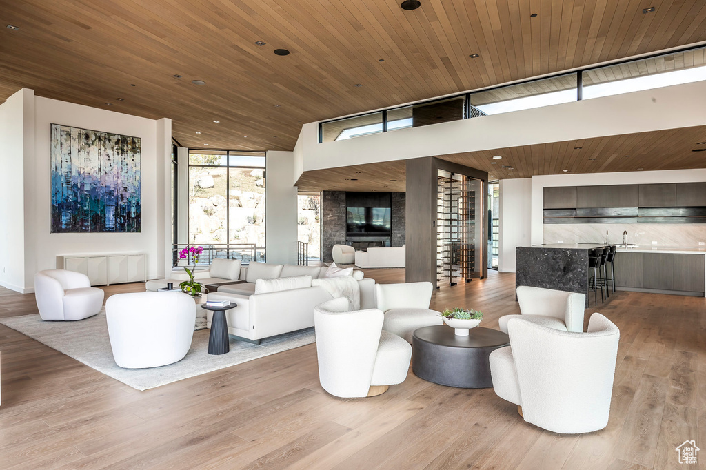 Living area featuring expansive windows, wood ceiling, and wood finished floors