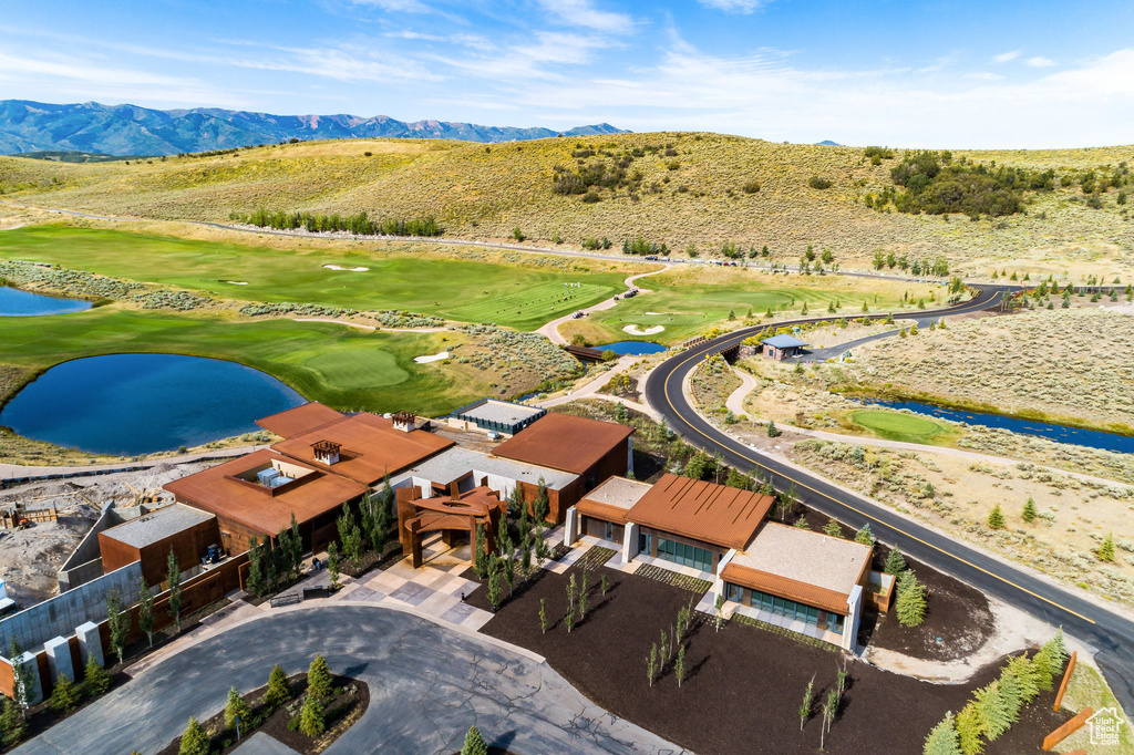 Bird's eye view of a golf course and a water and mountain view