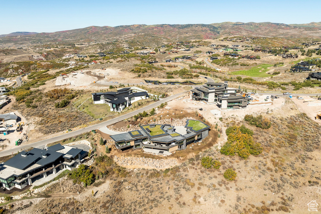 Aerial view of property's location with a mountainous background