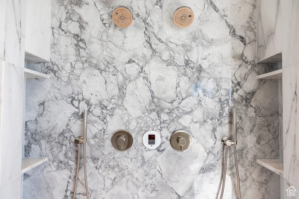 Bathroom featuring a marble finish shower