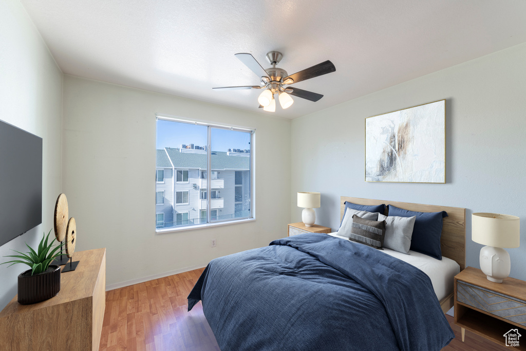 Bedroom featuring hardwood / wood-style floors and ceiling fan