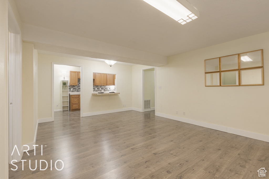 Empty room with hardwood / wood-style floors