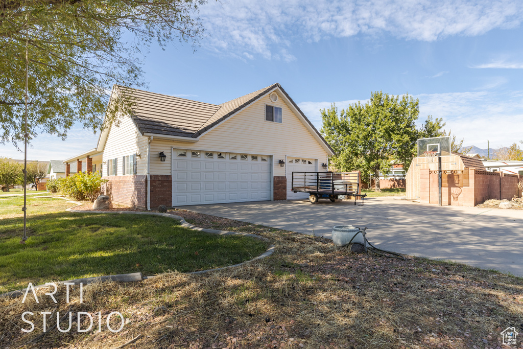 View of front facade with a garage and a front lawn