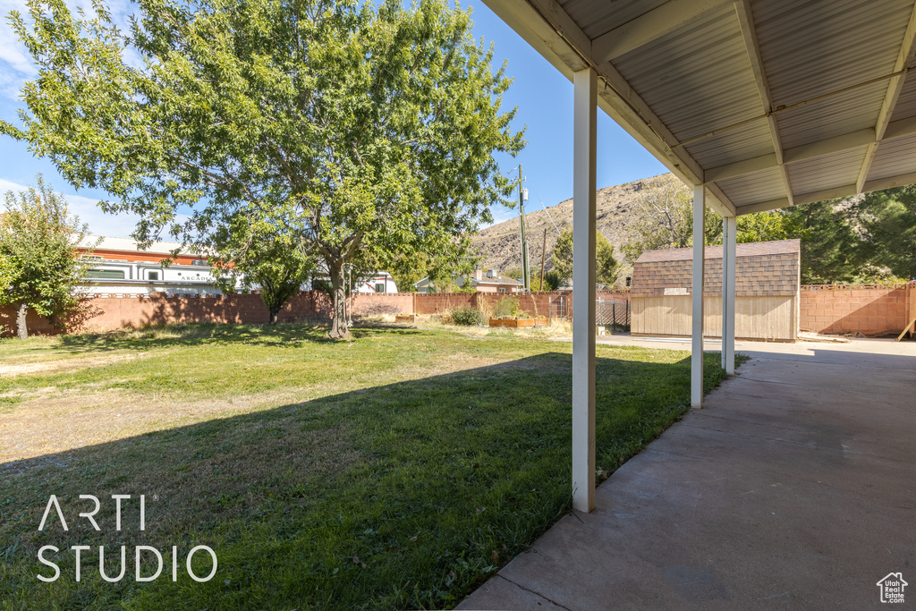 View of yard with a storage unit and a mountain view