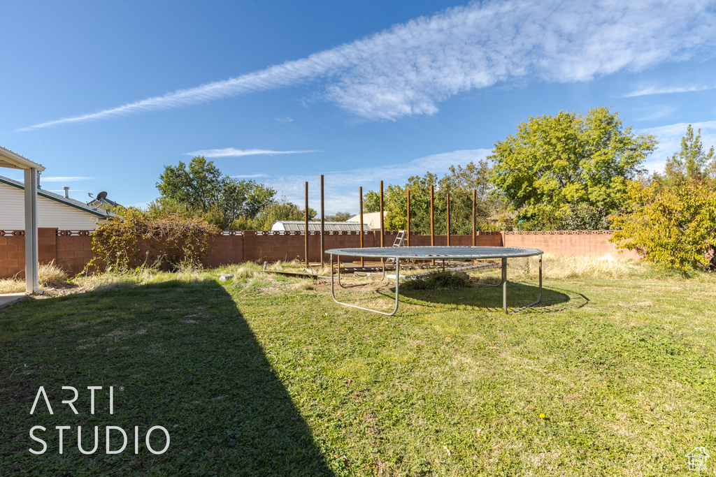 View of yard featuring a trampoline