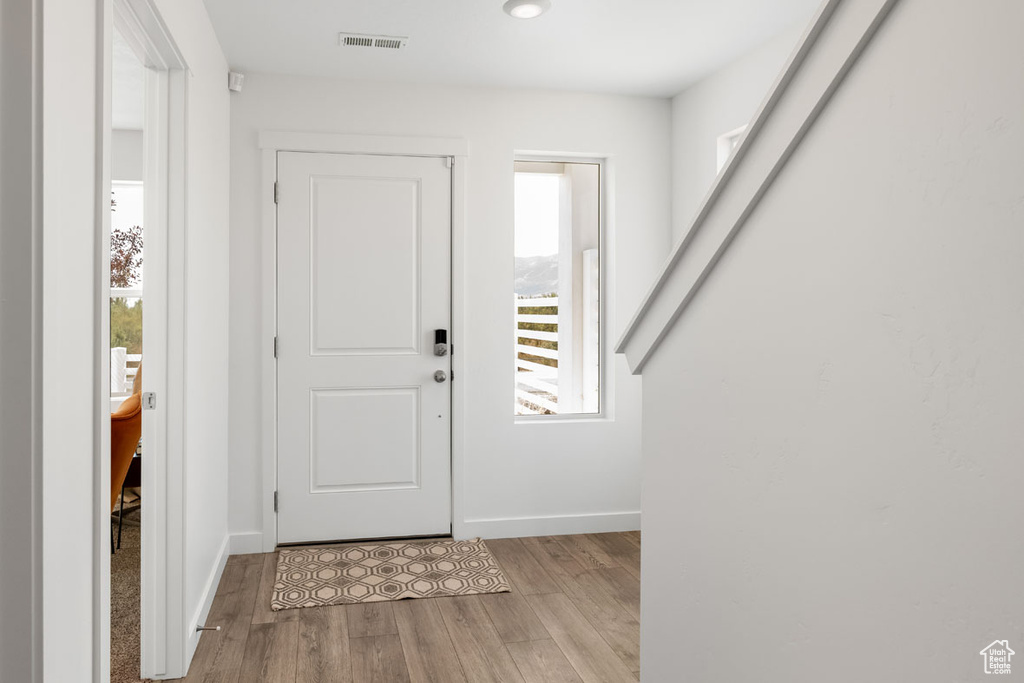Foyer entrance with light wood-type flooring