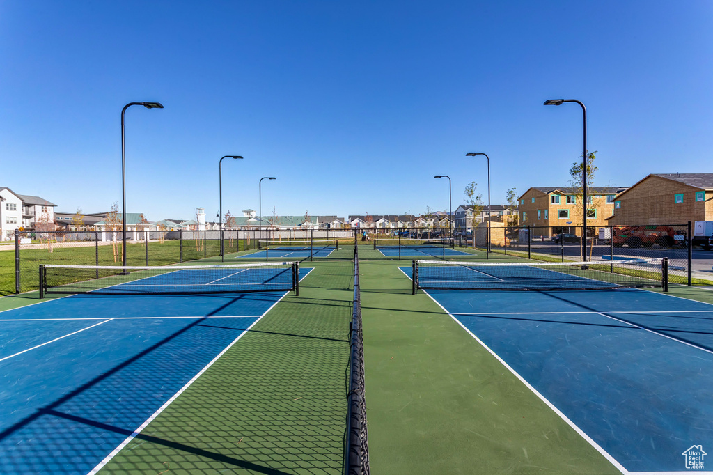 View of tennis court with basketball hoop