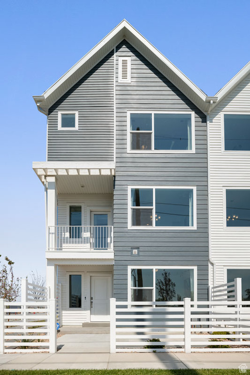 Back of property featuring a balcony