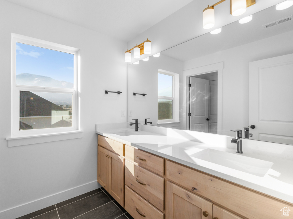 Bathroom with tile patterned flooring and vanity