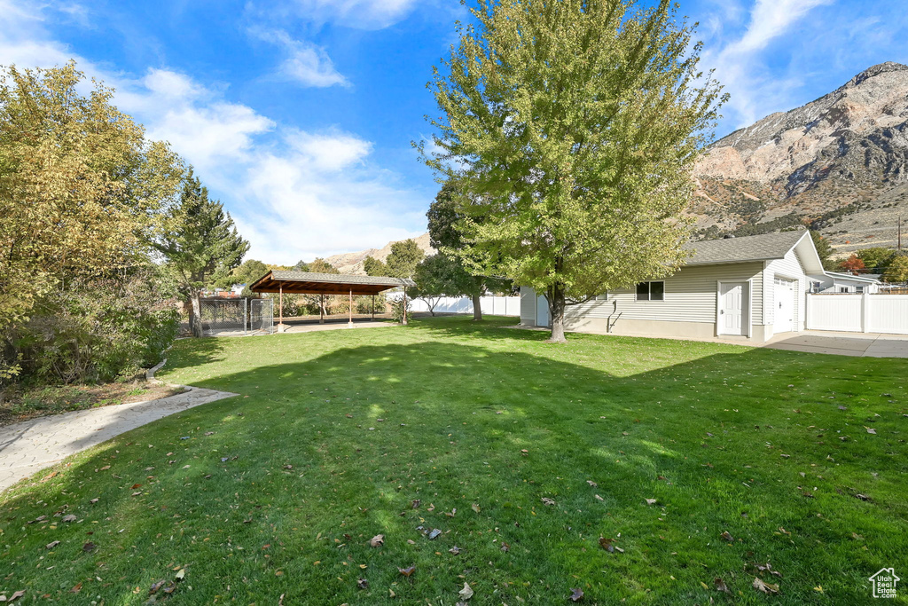 View of yard with a mountain view and a carport