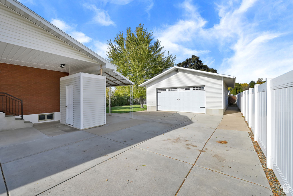 Garage featuring a carport