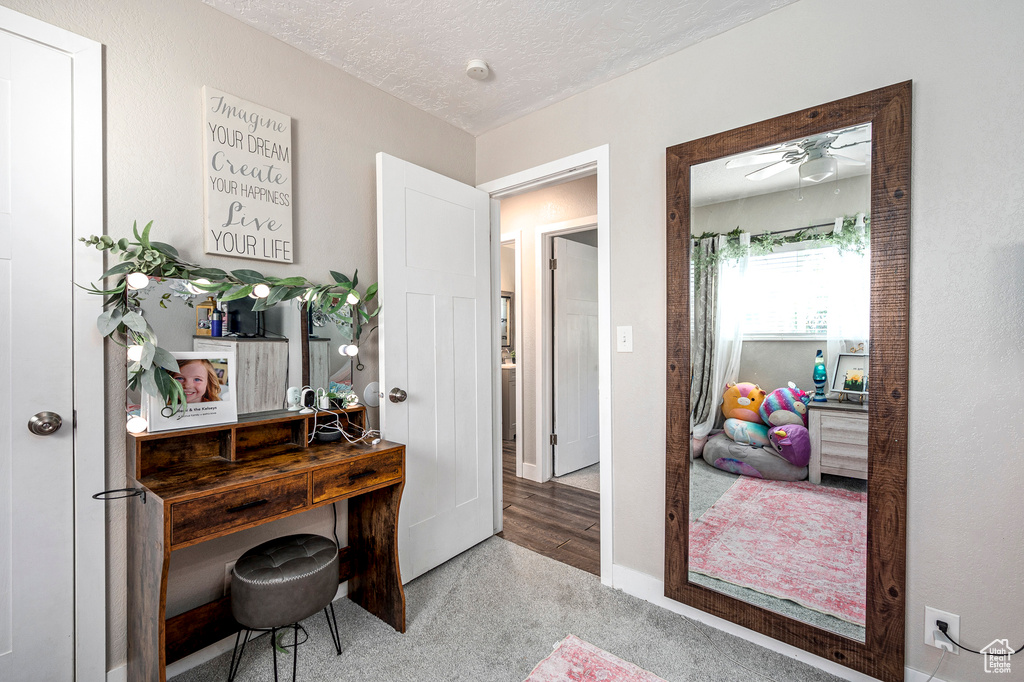 Interior space featuring ceiling fan and a textured ceiling