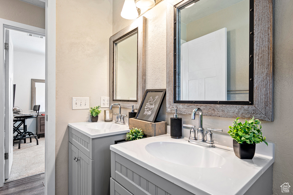 Bathroom featuring hardwood / wood-style flooring and vanity