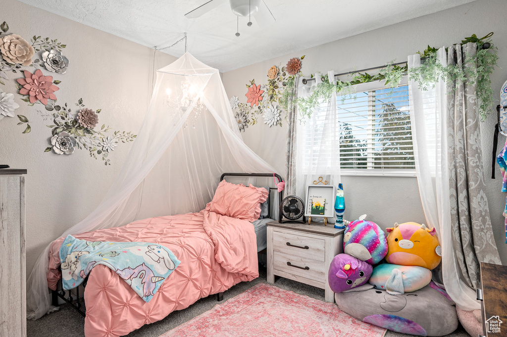 Carpeted bedroom with ceiling fan