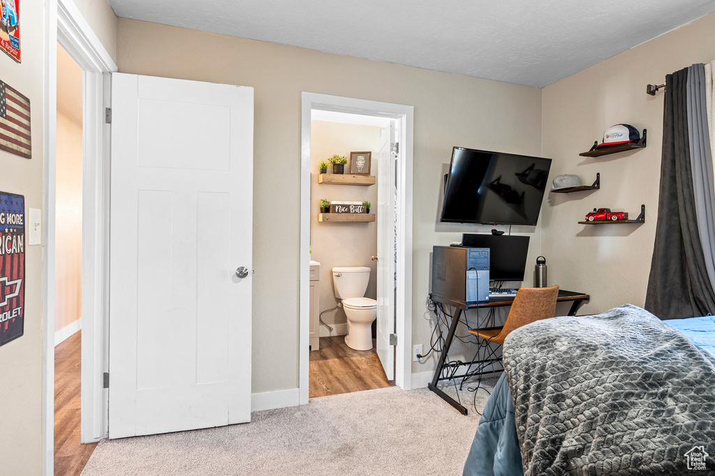 Bedroom featuring light hardwood / wood-style floors and ensuite bath