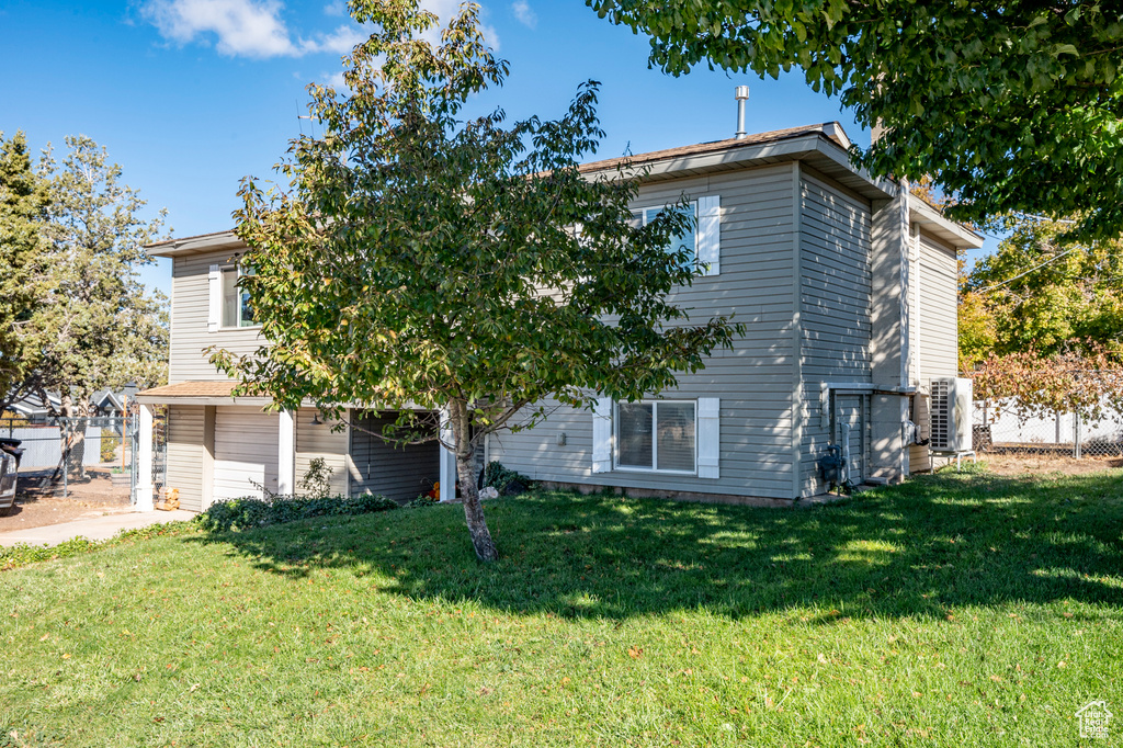 View of front facade with a front lawn and ac unit