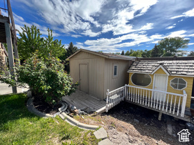 View of property exterior with a storage shed