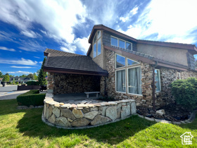 Rear view of property with a lawn