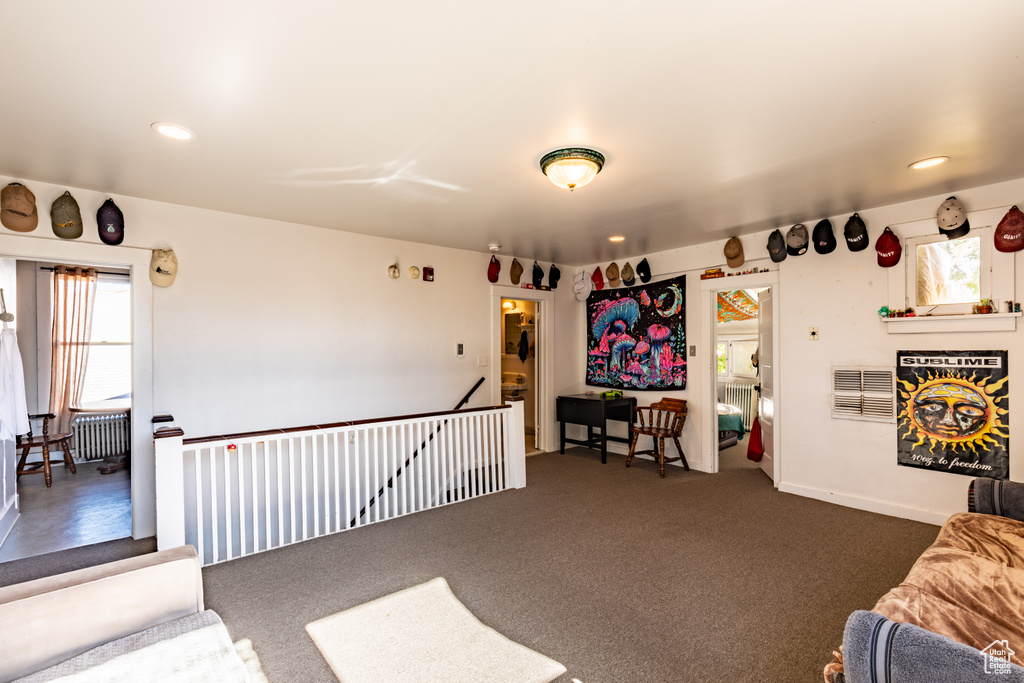 Carpeted living room with radiator heating unit