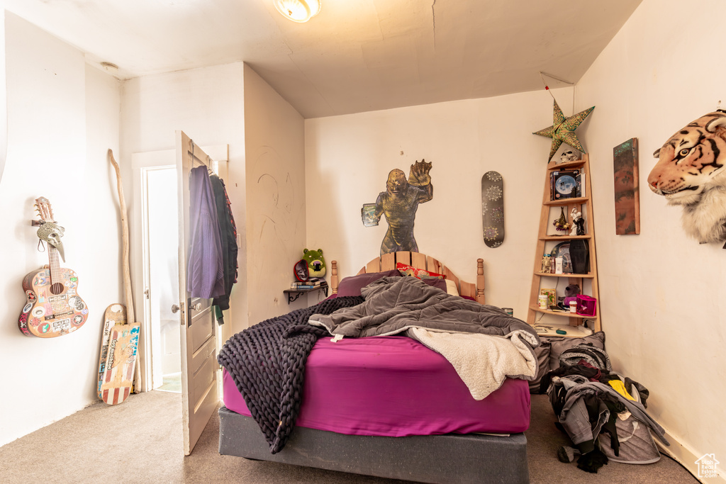 Carpeted bedroom featuring vaulted ceiling