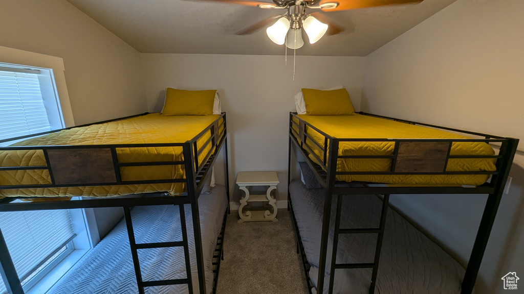 Carpeted bedroom with ceiling fan