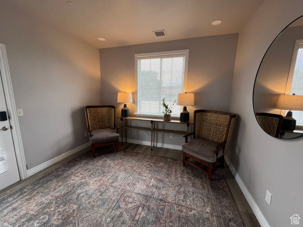 Living area with dark wood-type flooring