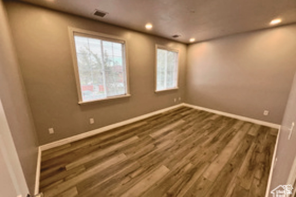 Unfurnished room featuring dark hardwood / wood-style floors