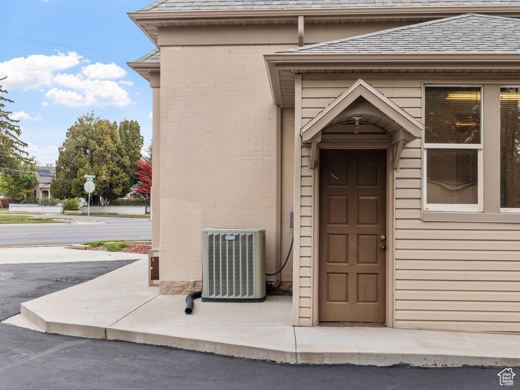 View of exterior entry featuring central air condition unit