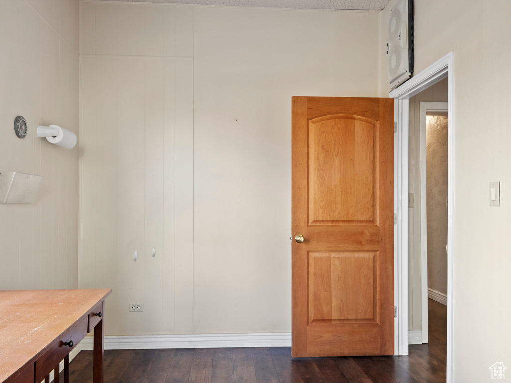 Corridor with dark hardwood / wood-style flooring