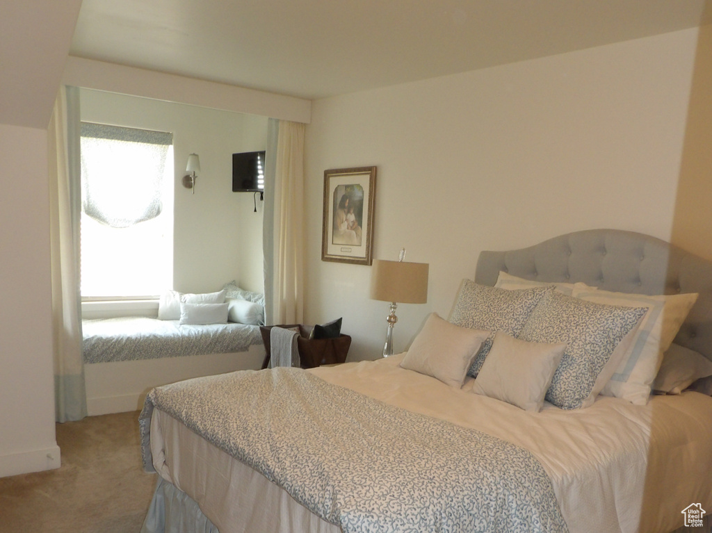 Bedroom featuring light carpet