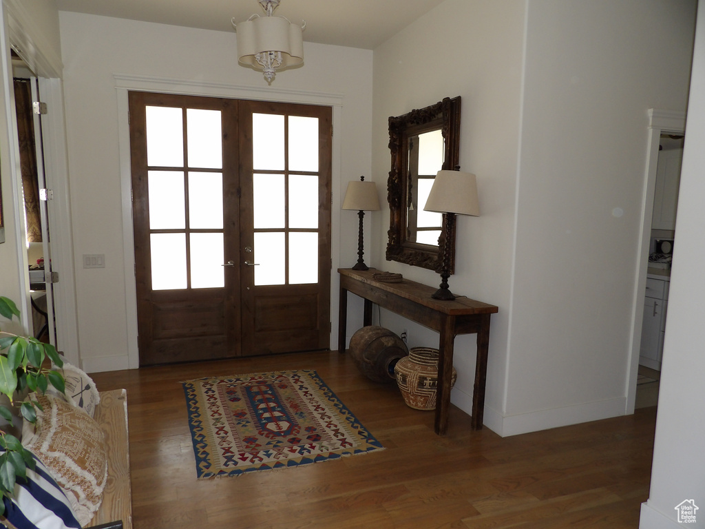 Foyer entrance with french doors and hardwood / wood-style flooring