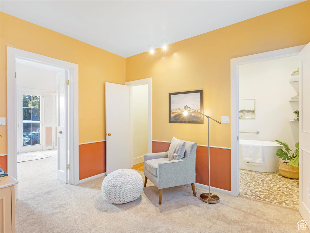 Living area featuring light colored carpet