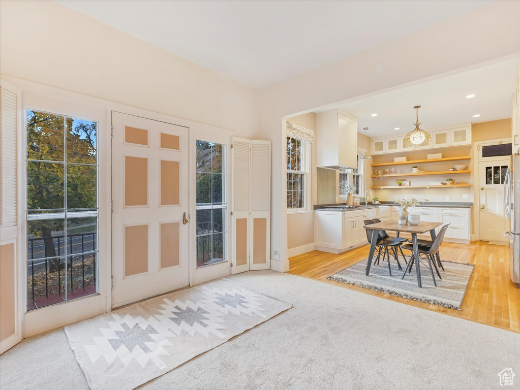 Dining room featuring light wood-type flooring and sink