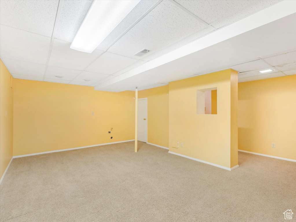 Basement with carpet and a drop ceiling