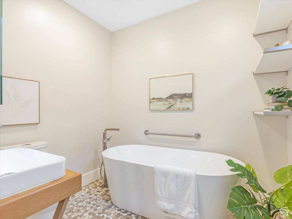 Bathroom featuring a bath and tile patterned floors