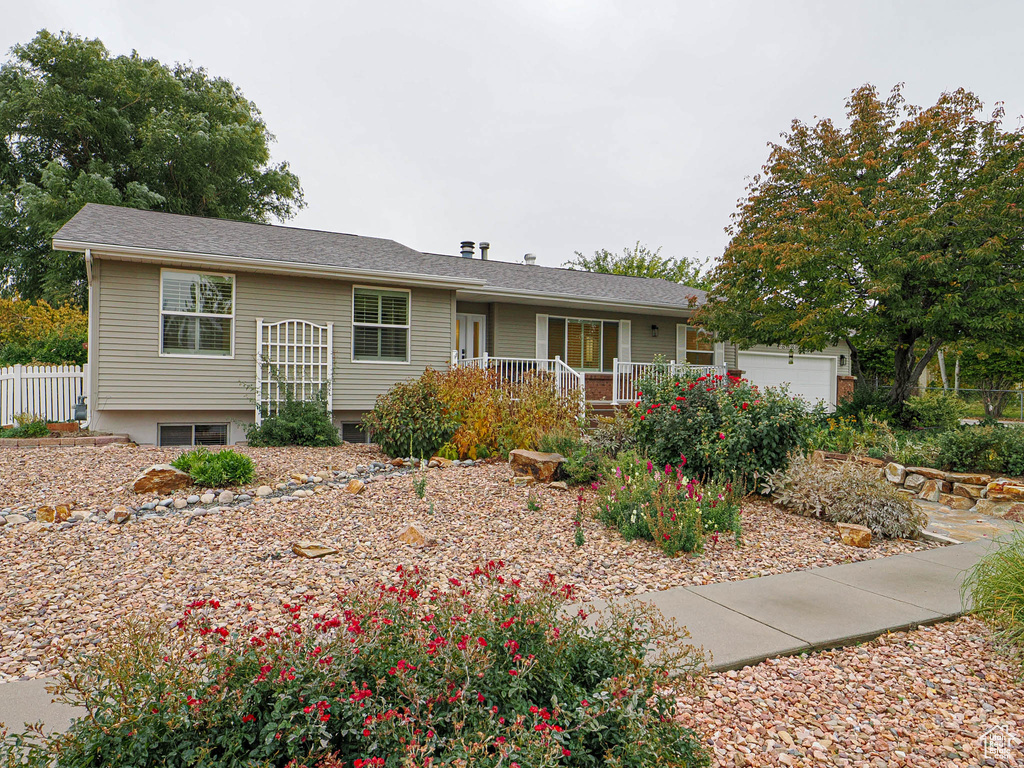 View of front of property featuring a garage and a porch