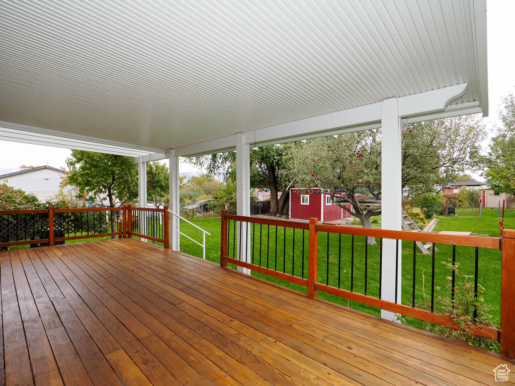 Wooden deck with a storage shed and a yard