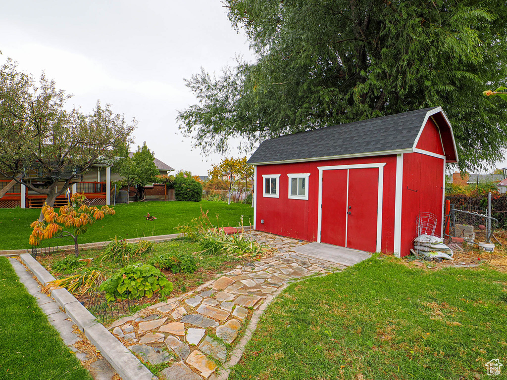 View of outdoor structure with a lawn